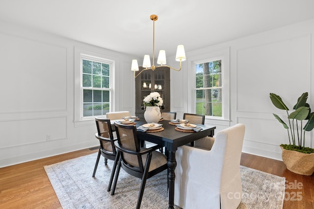 625 4th Street Dr NW, Hickory, NC 28601 - dining room with an inviting chandelier, wood finished floors, and a decorative wall