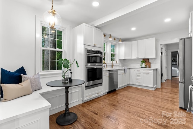 625 4th Street Dr NW, Hickory, NC 28601 - kitchen featuring light countertops, stainless steel appliances, white cabinetry, and light wood-type flooring