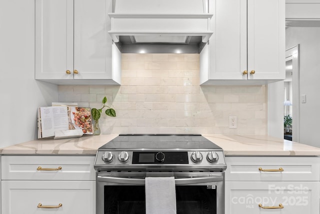 625 4th Street Dr NW, Hickory, NC 28601 - kitchen with electric range, light stone counters, white cabinetry, tasteful backsplash, and custom range hood