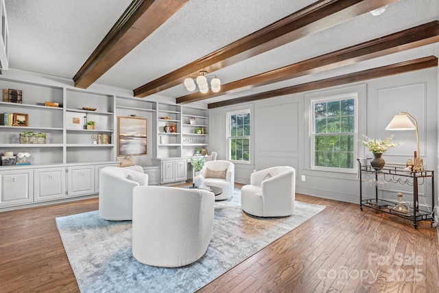 625 4th Street Dr NW, Hickory, NC 28601 - living room featuring light wood-style floors, beam ceiling, and a textured ceiling