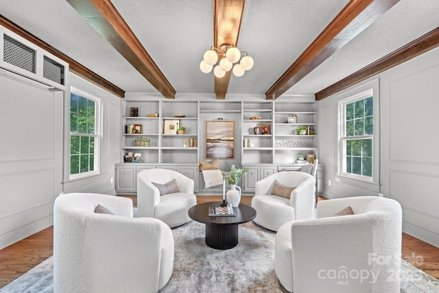 625 4th Street Dr NW, Hickory, NC 28601 - living area featuring plenty of natural light, wood finished floors, a notable chandelier, and beamed ceiling