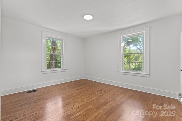 625 4th Street Dr NW, Hickory, NC 28601 - empty room with baseboards, plenty of natural light, wood finished floors, and visible vents