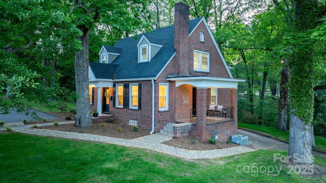 625 4th Street Dr NW, Hickory, NC 28601 - english style home with brick siding, a front yard, covered porch, and a chimney