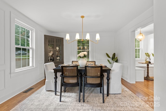 625 4th Street Dr NW, Hickory, NC 28601 - dining room featuring wood finished floors, plenty of natural light, a chandelier, and visible vents