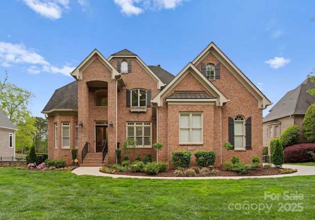 13420 Robert Walker Dr, Davidson, NC 28036 - view of front of house featuring brick siding, a front yard, a standing seam roof, and metal roof