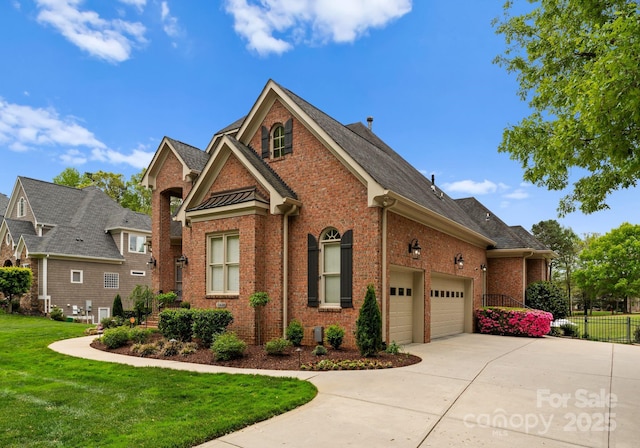 13420 Robert Walker Dr, Davidson, NC 28036 - view of front of house with brick siding, driveway, a front yard, and fence
