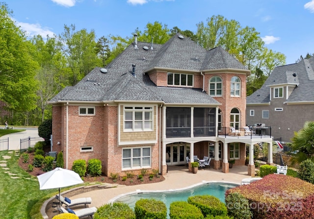 13420 Robert Walker Dr, Davidson, NC 28036 - back of house featuring fence, a patio, a fenced in pool, brick siding, and a sunroom