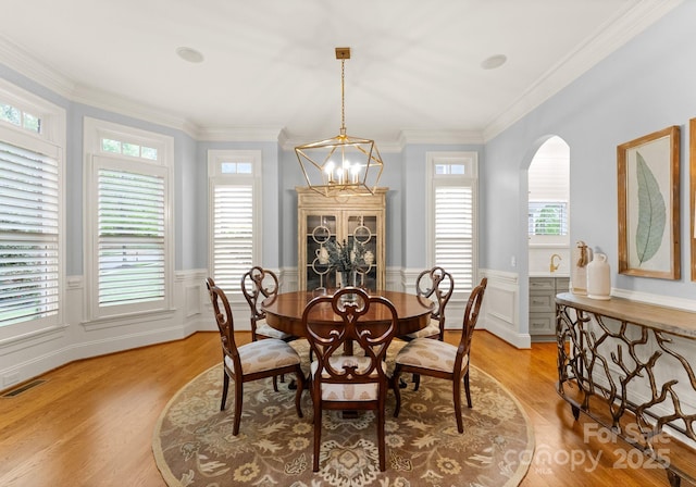 13420 Robert Walker Dr, Davidson, NC 28036 - dining area featuring visible vents, light wood finished floors, a wealth of natural light, and wainscoting