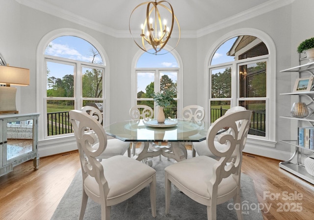 13420 Robert Walker Dr, Davidson, NC 28036 - dining area with light wood-style flooring, baseboards, a notable chandelier, and ornamental molding