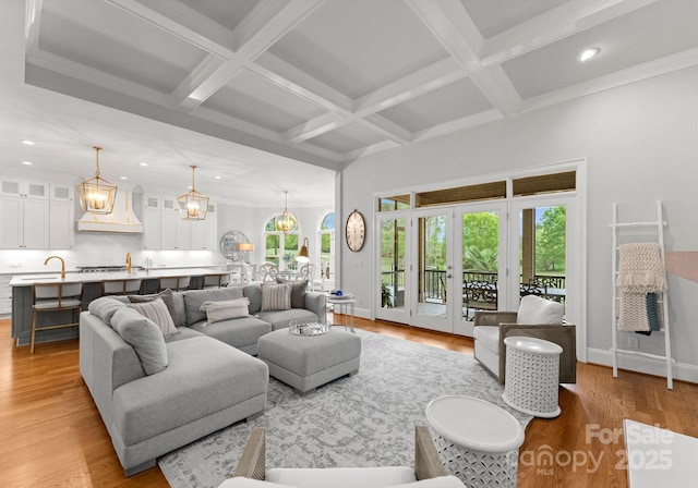 13420 Robert Walker Dr, Davidson, NC 28036 - living area with a notable chandelier, beam ceiling, light wood-style floors, and recessed lighting