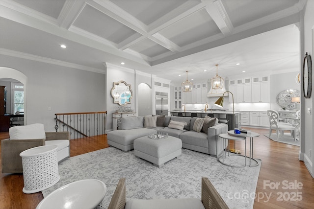 13420 Robert Walker Dr, Davidson, NC 28036 - living area featuring beam ceiling, wood finished floors, arched walkways, and recessed lighting