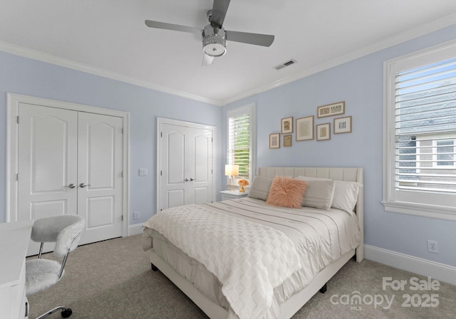 13420 Robert Walker Dr, Davidson, NC 28036 - bedroom featuring crown molding, two closets, carpet floors, baseboards, and visible vents