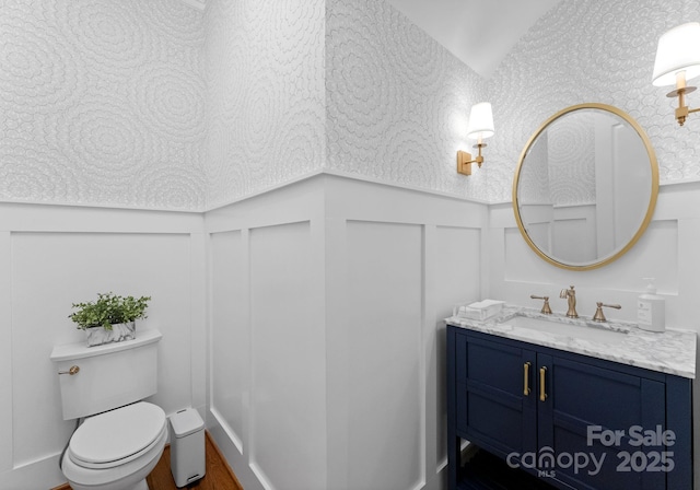13420 Robert Walker Dr, Davidson, NC 28036 - bathroom with a decorative wall, toilet, vanity, and a wainscoted wall