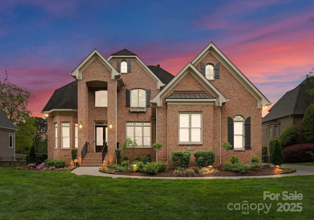 13420 Robert Walker Dr, Davidson, NC 28036 - traditional-style house with a standing seam roof, a front lawn, brick siding, and metal roof