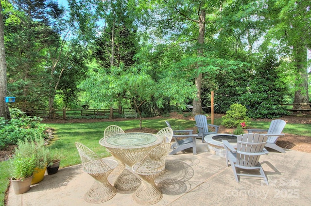 view of patio with fence private yard and an outdoor fire pit
