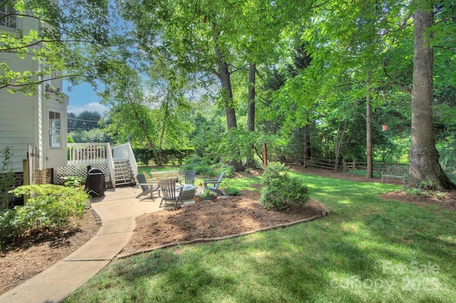 view of yard featuring a patio area, fence, and a deck