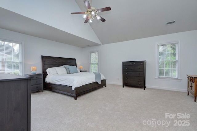 bedroom with visible vents, baseboards, multiple windows, and light colored carpet