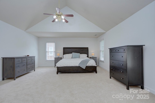 bedroom with a ceiling fan, baseboards, light colored carpet, and high vaulted ceiling