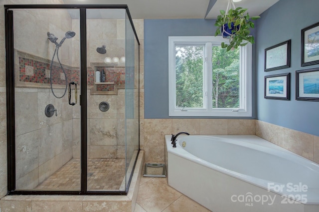 bathroom featuring tile patterned floors, a shower stall, and a garden tub