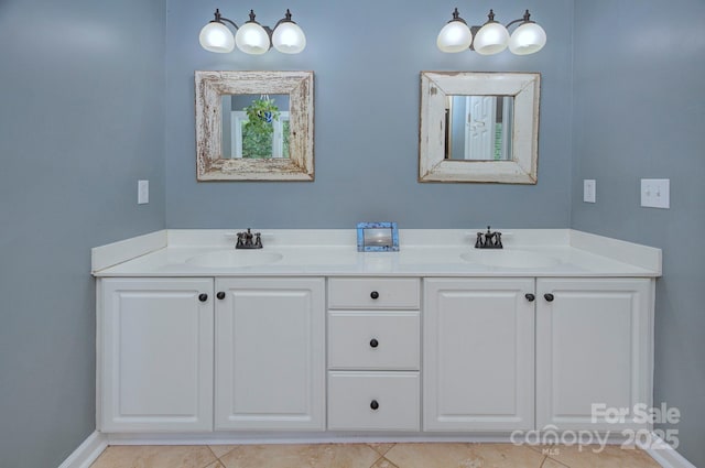 bathroom featuring a sink, tile patterned floors, baseboards, and double vanity