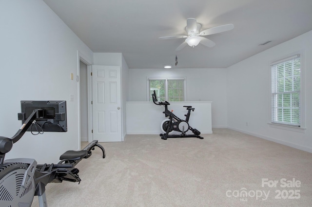 exercise area featuring carpet floors, ceiling fan, and a healthy amount of sunlight