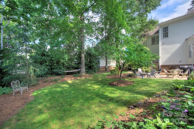 view of yard featuring a patio and a fire pit