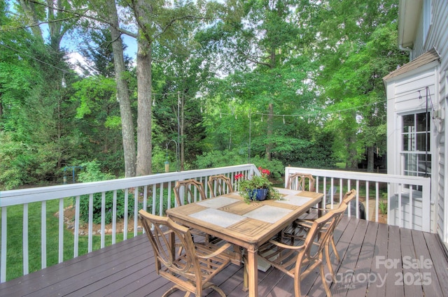 deck with outdoor dining area