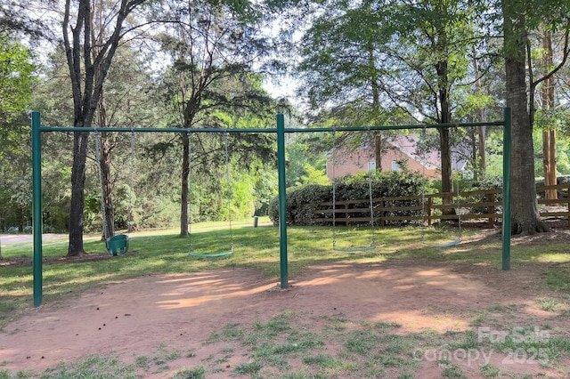 view of home's community with fence and a lawn