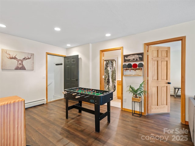 rec room featuring dark wood-type flooring, recessed lighting, and baseboard heating
