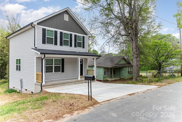 traditional-style house featuring a porch and crawl space