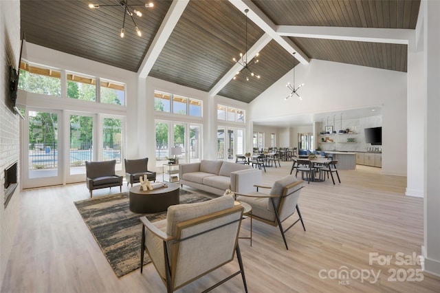 living room featuring light wood-style floors, high vaulted ceiling, beamed ceiling, a fireplace, and wood ceiling