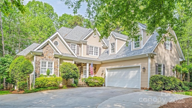 19729 Callaway Hills Ln, Davidson, NC 28036 - view of front of house featuring stone siding, an attached garage, roof with shingles, and concrete driveway