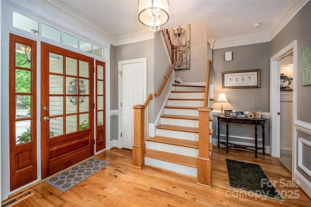 19729 Callaway Hills Ln, Davidson, NC 28036 - entryway featuring wood finished floors, visible vents, crown molding, and plenty of natural light