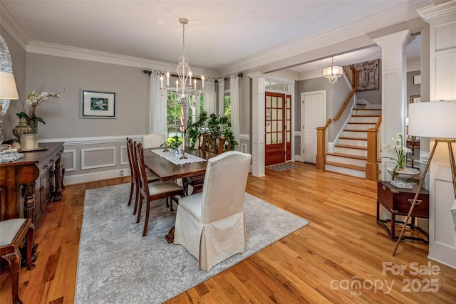 19729 Callaway Hills Ln, Davidson, NC 28036 - dining area with crown molding, a chandelier, light wood finished floors, and decorative columns