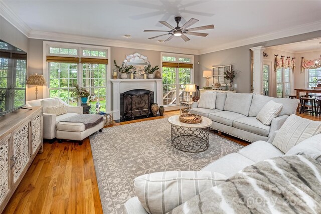 19729 Callaway Hills Ln, Davidson, NC 28036 - living room featuring a fireplace with flush hearth, a ceiling fan, crown molding, and wood finished floors
