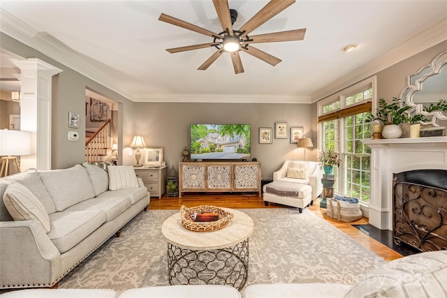 19729 Callaway Hills Ln, Davidson, NC 28036 - living room featuring a fireplace with flush hearth, a ceiling fan, wood finished floors, stairway, and crown molding