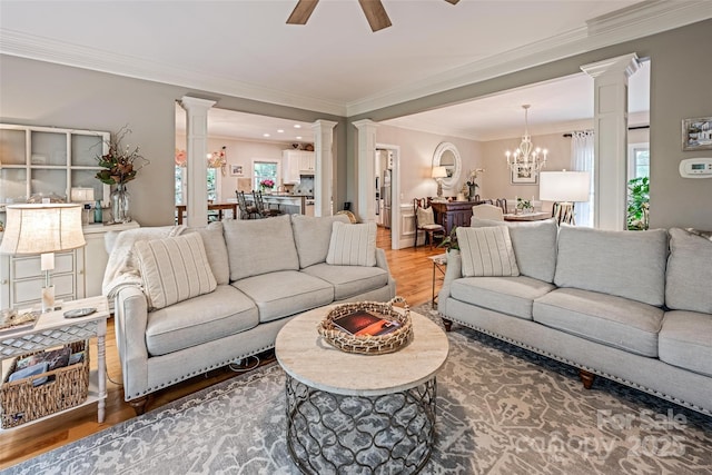 19729 Callaway Hills Ln, Davidson, NC 28036 - living area featuring ceiling fan with notable chandelier, crown molding, wood finished floors, and decorative columns