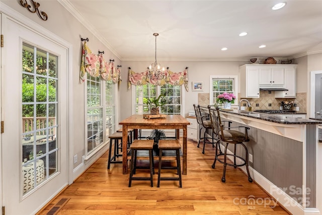 19729 Callaway Hills Ln, Davidson, NC 28036 - dining area with recessed lighting, crown molding, light wood finished floors, and a notable chandelier