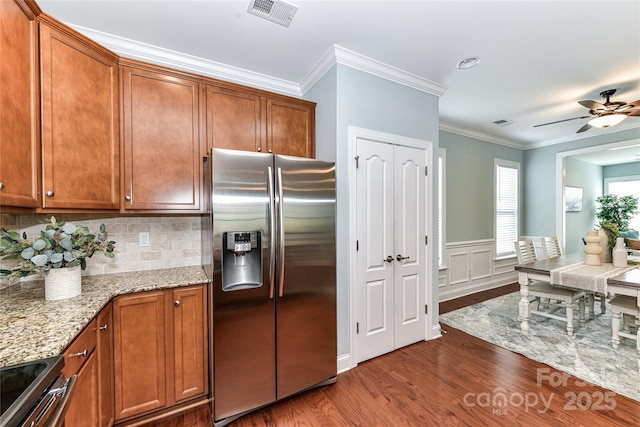 11123 Bailey Park Nature Dr, Cornelius, NC 28031 - kitchen with brown cabinetry, visible vents, appliances with stainless steel finishes, and dark wood-style flooring