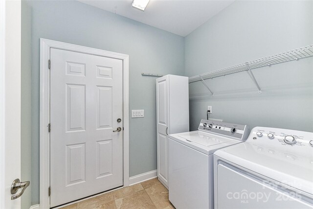 11123 Bailey Park Nature Dr, Cornelius, NC 28031 - clothes washing area with baseboards, washer and dryer, and cabinet space