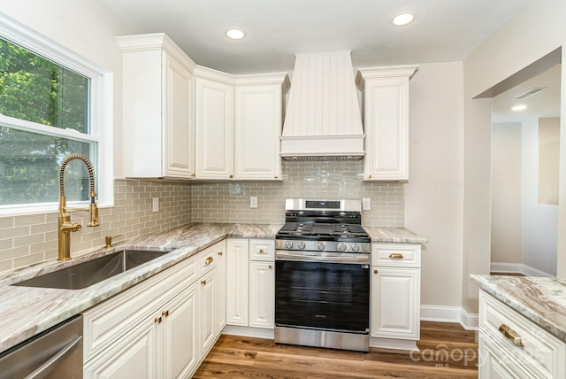 112 Circle Dr, Salisbury, NC 28144 - kitchen featuring stainless steel appliances, custom range hood, a sink, wood finished floors, and light stone counters