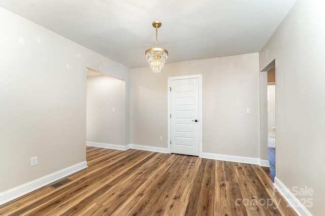 112 Circle Dr, Salisbury, NC 28144 - unfurnished room with wood finished floors, baseboards, and a chandelier