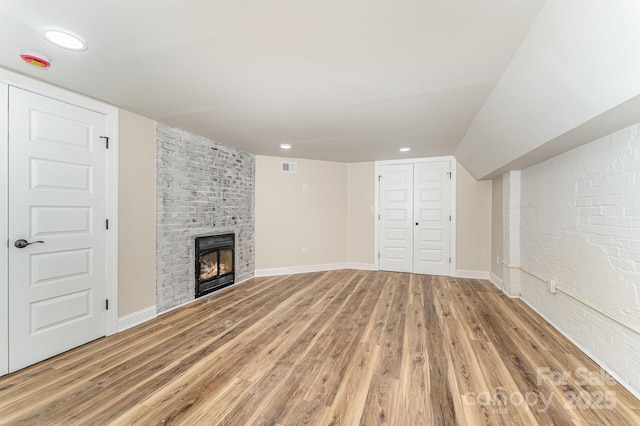112 Circle Dr, Salisbury, NC 28144 - unfurnished living room featuring light wood finished floors, a brick fireplace, baseboards, and recessed lighting