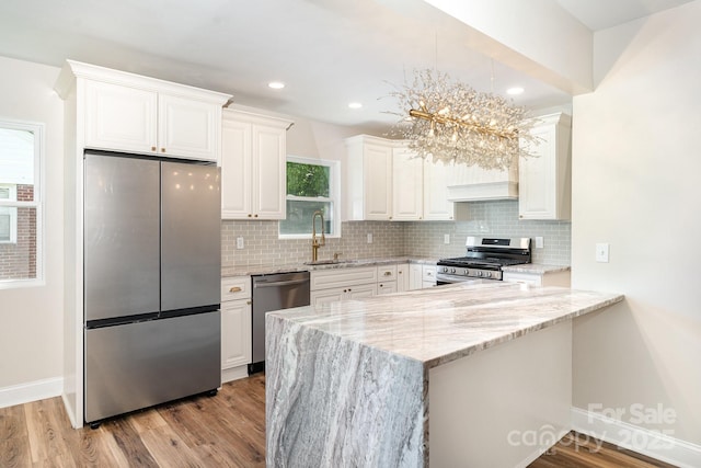 112 Circle Dr, Salisbury, NC 28144 - kitchen with stainless steel appliances, a sink, baseboards, light stone counters, and recessed lighting