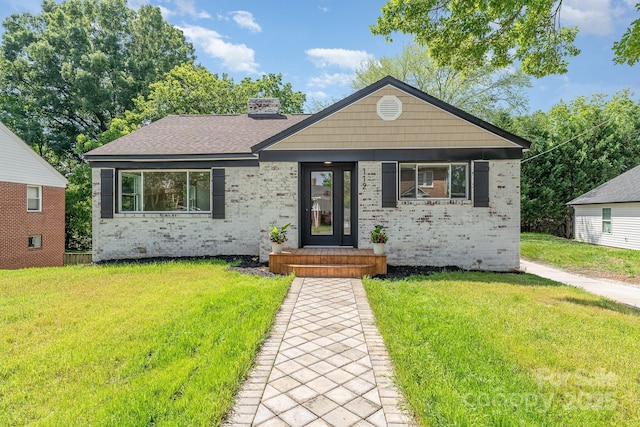112 Circle Dr, Salisbury, NC 28144 - view of front facade featuring brick siding, a front lawn, and a chimney