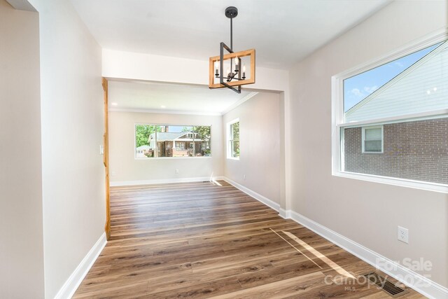 112 Circle Dr, Salisbury, NC 28144 - unfurnished dining area with a chandelier, wood finished floors, baseboards, and ornamental molding