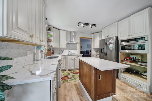 kitchen featuring open shelves, wall chimney exhaust hood, white cabinets, a sink, and stainless steel appliances