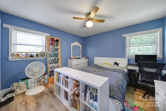 bedroom with ceiling fan and wood finished floors