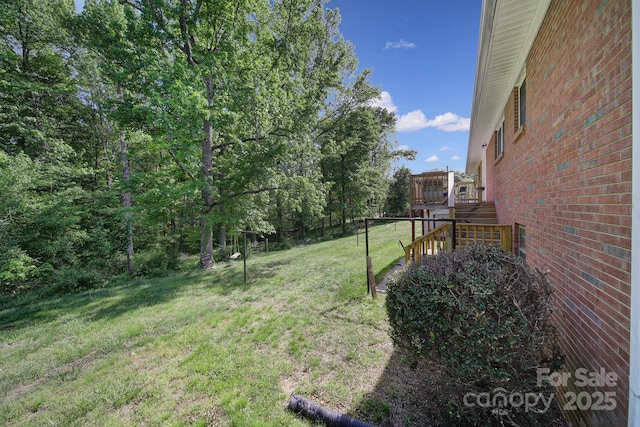 view of yard with a wooden deck and stairway