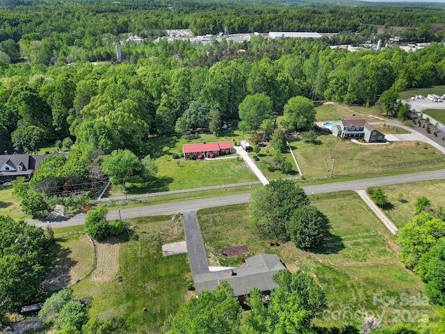 birds eye view of property featuring a view of trees